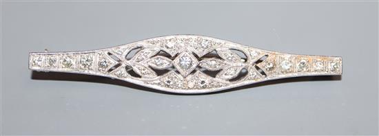 A 1920s pierced white metal and diamond set bar brooch, 54mm.